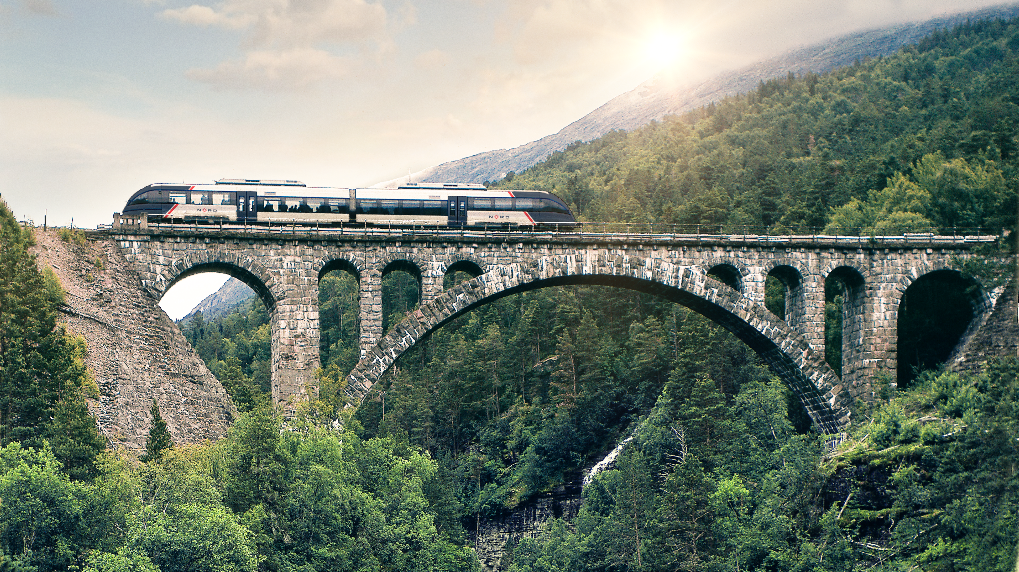 An SJ Nord train passes the Kylling bridge over the Verma waterfall